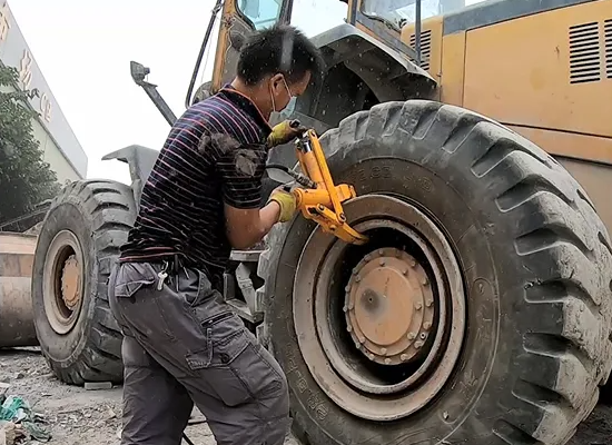 A special machine called loader tire changer can safely push the tire off the rim.